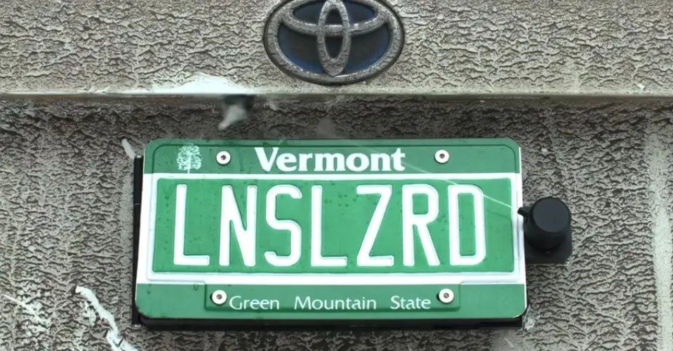 This backup camera cleaner hides behind your license plate