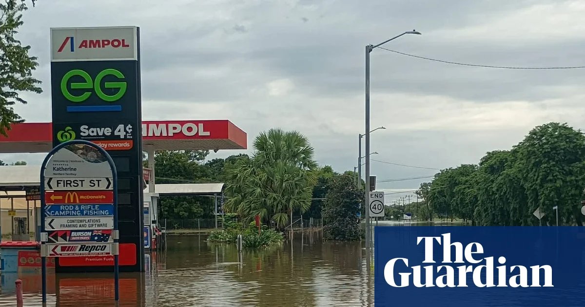 ‘A saltwater crocodile on the AFL oval’: worst flooding in decades inundates the NT as residents urged to avoid water | Flooding
