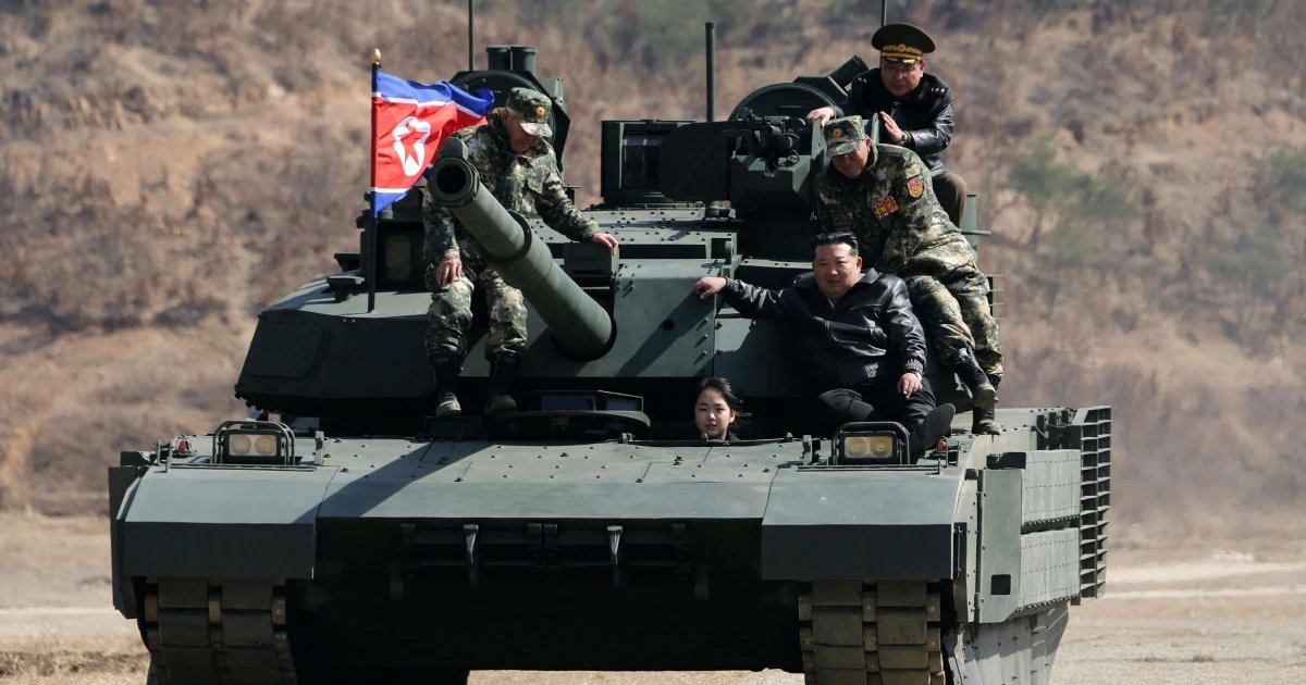 North Korean leader Kim and his daughter ride a tank together during army training