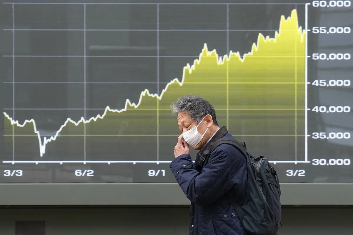 Asia shares are mostly lower and oil hovers near $100 a barrel over Iran war worries