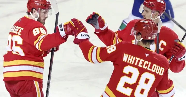 Flames ignite offence, burn Canucks 7-3