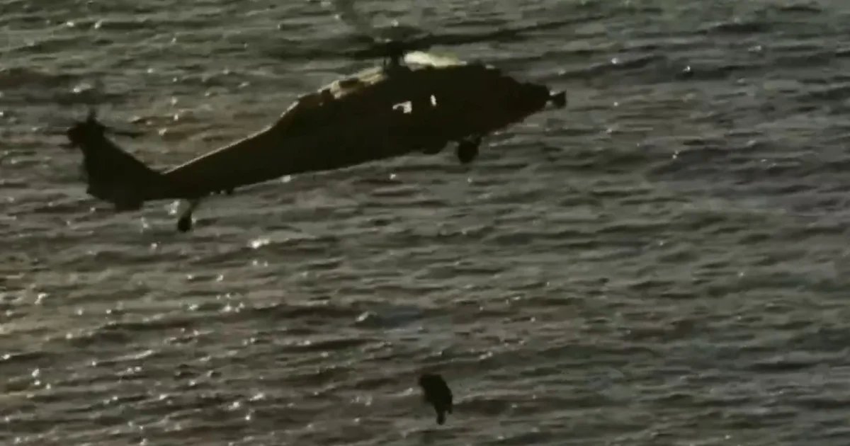 Astronauts hoisted by helicopter from splashdown site