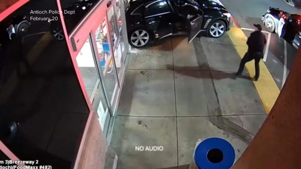 WATCH:  Newly released video shows a suspect driving off with a police officer in the car