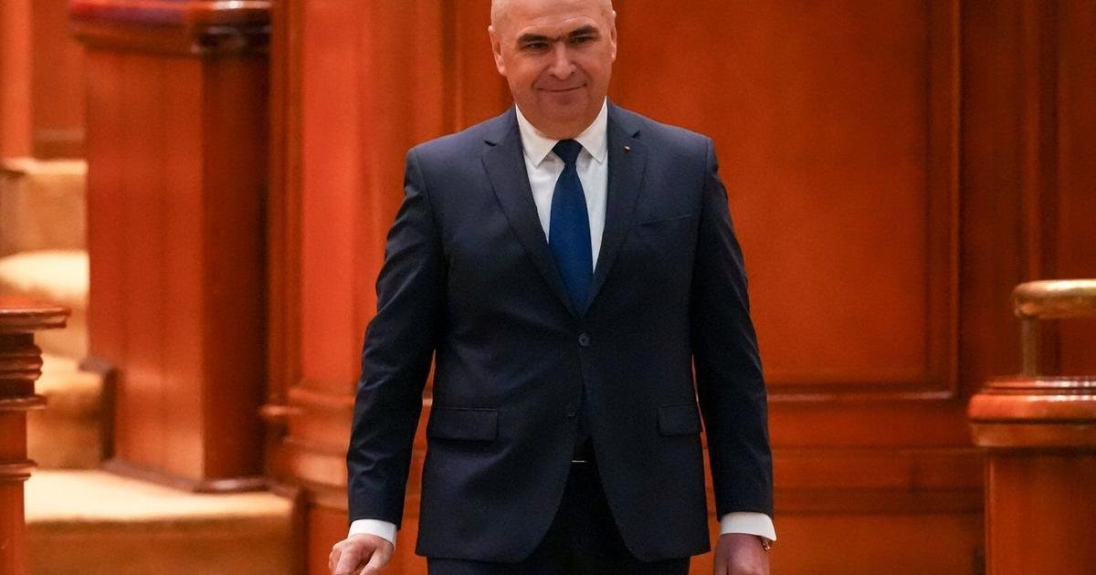 Romania's prime minister fights for survival as no-confidence motion is debated in Parliament