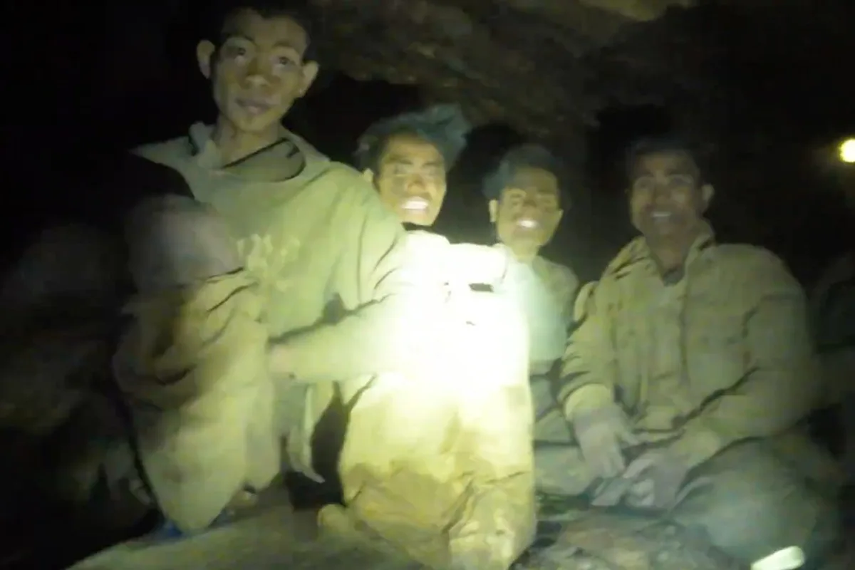 Rescuers evacuate the first of 5 villagers found trapped in a cave in Laos; 2 still missing