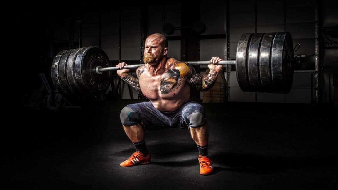 The physics of how Olympic weightlifters exploit barbell’s “whip”