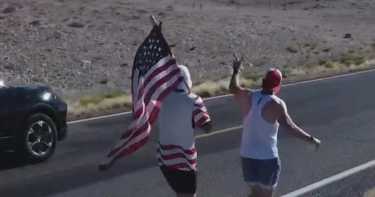 Group running American flag from coast to coast