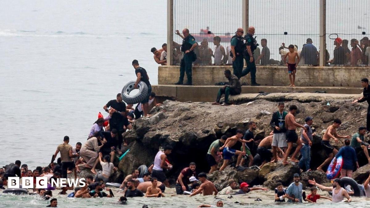 Hundreds of migrants swim from Morocco to Spanish enclave of Ceuta