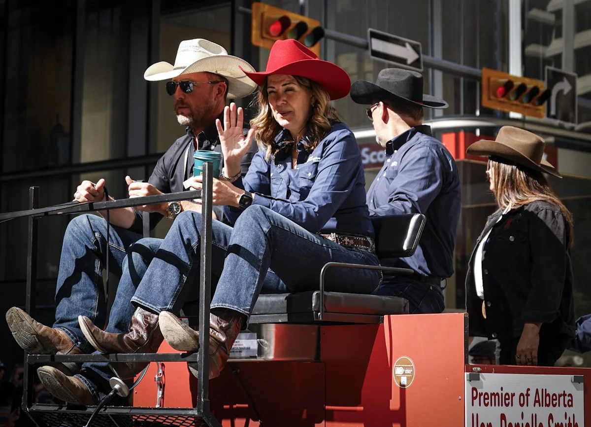 ‘You suuuuuck!’: Smith gets cheers and jeers riding in Calgary Stampede parade