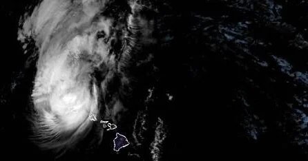 Hurricane Lowell passing just west of Hawaii, bringing heavy rain, strong winds, punishing waves